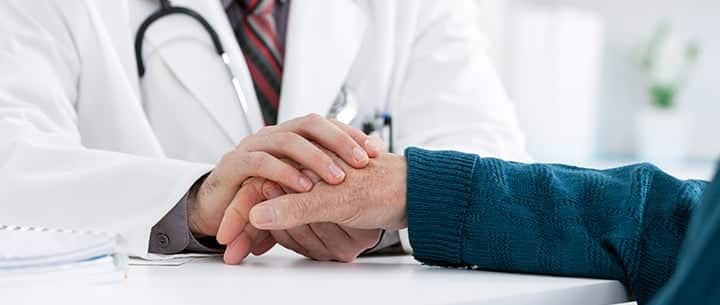 doctor holding patient’s hand