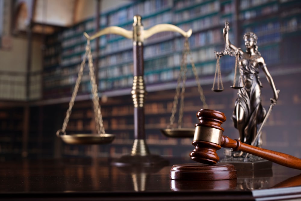 Judge's gavel with library background — symbolizing legal justice for asbestos exposure victims.