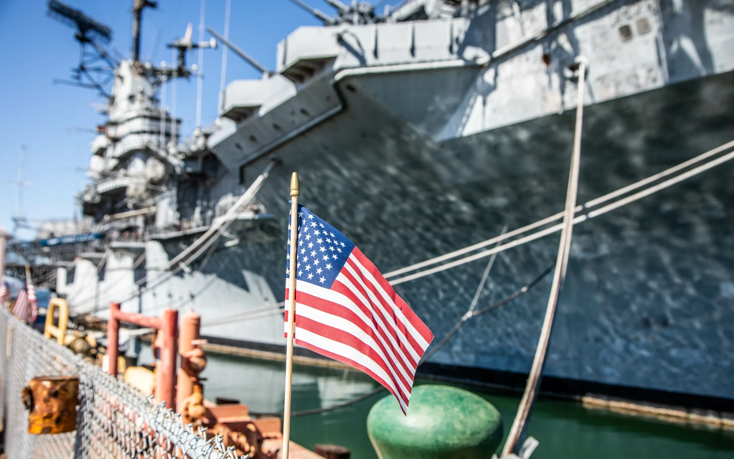 Navy ship with the U.S. flag — symbolizing the connection between military service and asbestos exposure among Navy veterans.