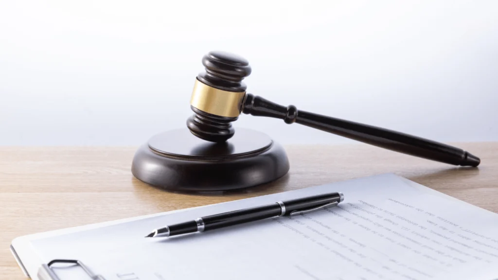Courtroom gavel and legal paperwork symbolizing asbestos wrongful death settlements.
