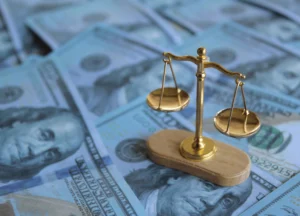 scales of justice with money against medical expenses